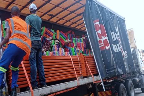 DV B-CO team loading pallets of brooms onto a delivery truck